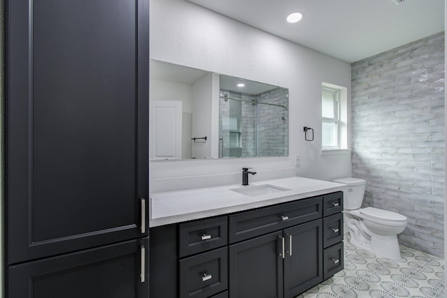 bathroom featuring tile walls, vanity, toilet, and a shower with door