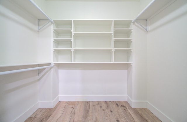 walk in closet featuring light hardwood / wood-style flooring