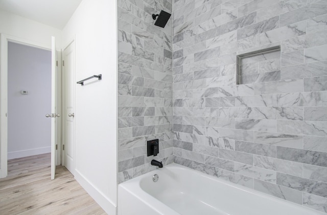 bathroom with tiled shower / bath combo and hardwood / wood-style flooring