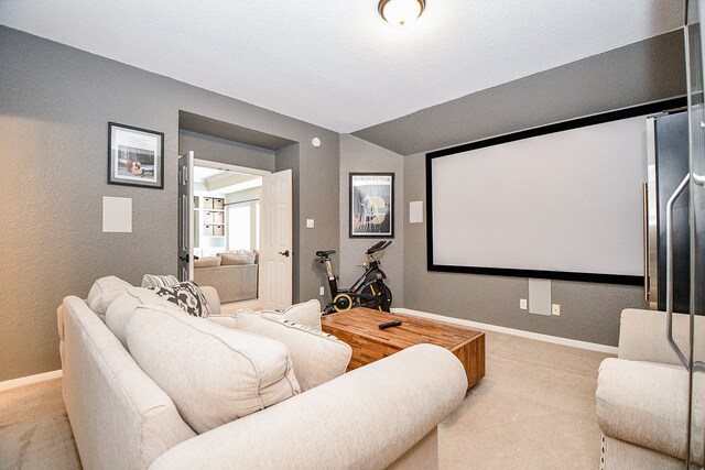 carpeted cinema with lofted ceiling