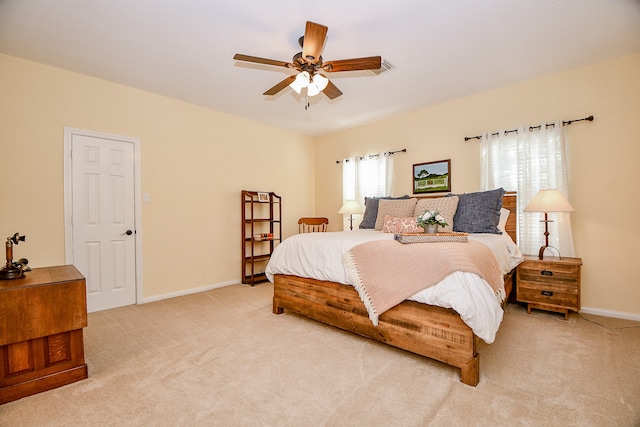 bedroom featuring light carpet and ceiling fan