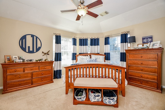 bedroom featuring light carpet, multiple windows, lofted ceiling, and ceiling fan