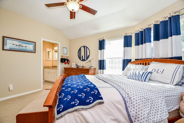 bedroom featuring ceiling fan, light colored carpet, connected bathroom, and vaulted ceiling