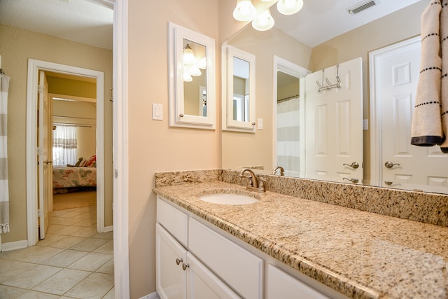 bathroom with tile patterned flooring and vanity