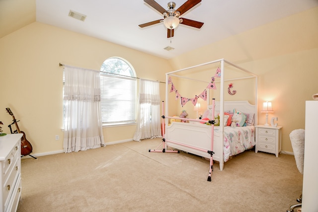 carpeted bedroom with ceiling fan and vaulted ceiling