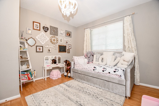 bedroom featuring light hardwood / wood-style flooring and a notable chandelier