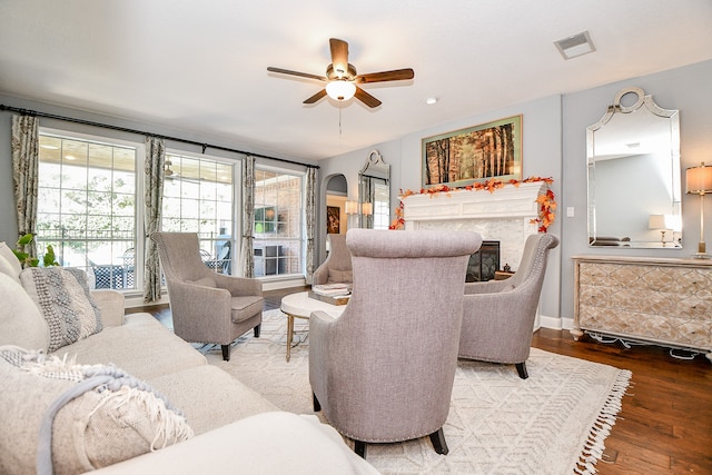 living room featuring hardwood / wood-style floors and ceiling fan