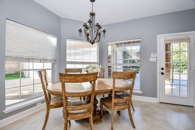 dining area featuring a chandelier and light tile patterned flooring