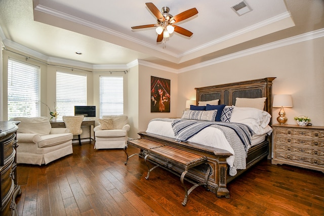 bedroom featuring a raised ceiling, ceiling fan, dark hardwood / wood-style floors, and ornamental molding