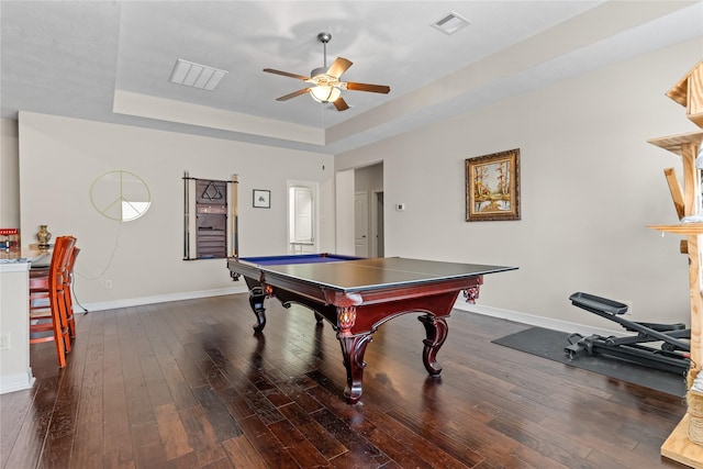 game room featuring ceiling fan, dark hardwood / wood-style flooring, and a tray ceiling