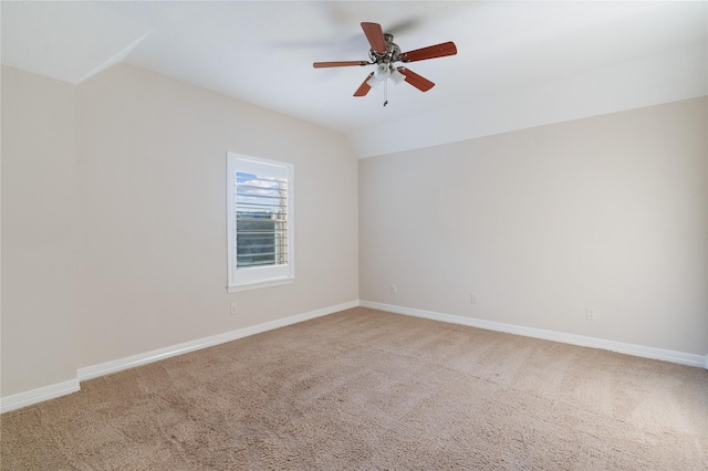 carpeted empty room with vaulted ceiling and ceiling fan