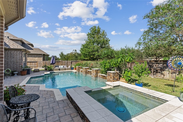 view of swimming pool with a patio area and an in ground hot tub