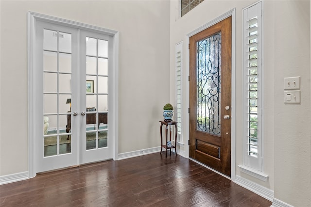 foyer entrance with dark hardwood / wood-style floors and french doors