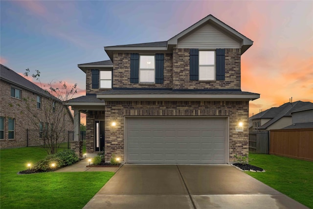 front facade with a yard and a garage