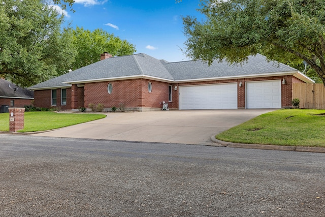 ranch-style home featuring a garage and a front yard