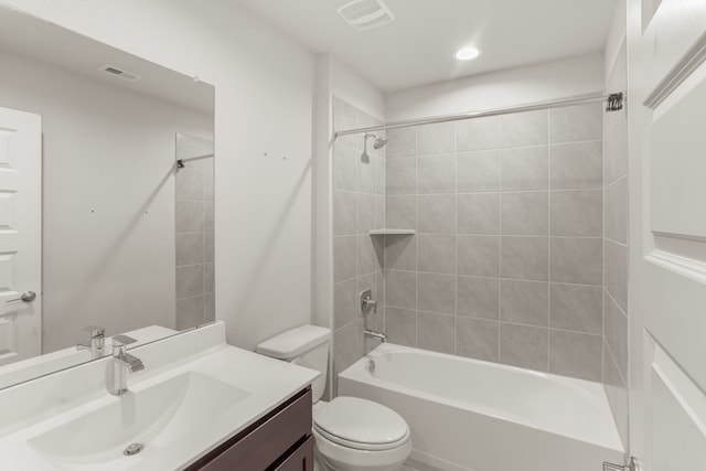 full bathroom with vanity, toilet, and tiled shower / bath combo