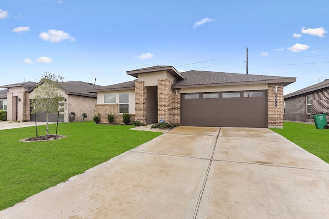 prairie-style home featuring a front yard and a garage