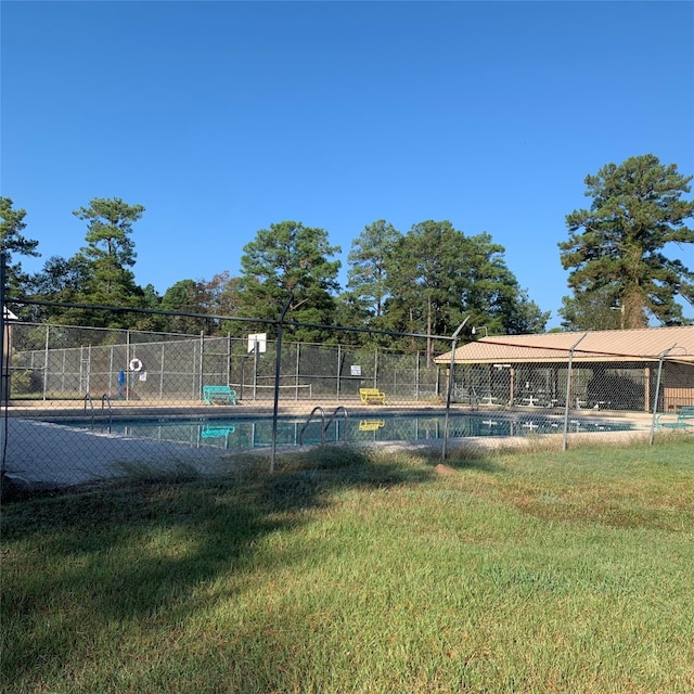 view of pool featuring a yard