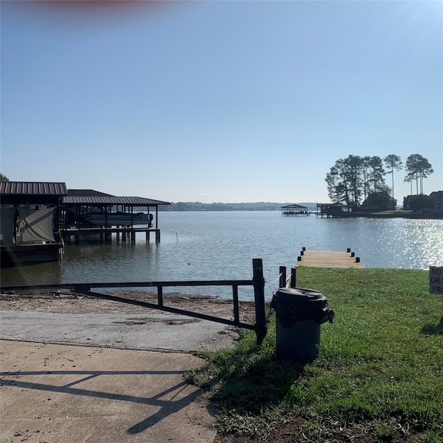 dock area featuring a water view and a yard