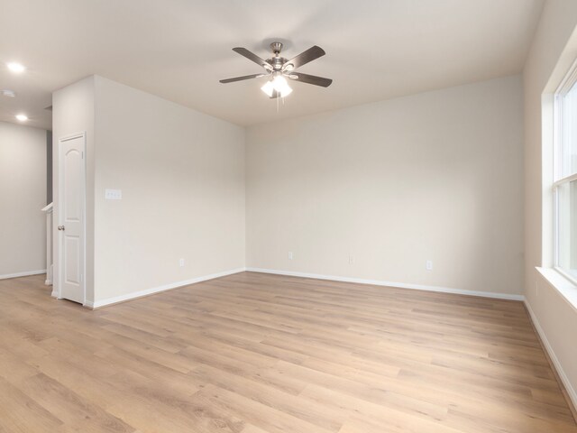 spare room featuring ceiling fan and light wood-type flooring