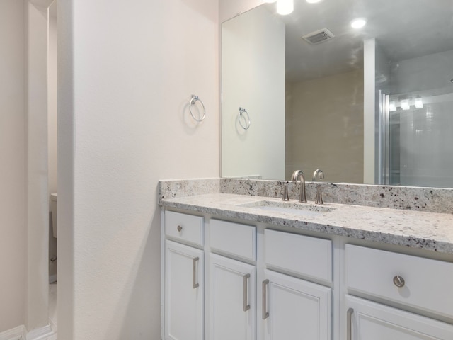 bathroom with vanity and a shower