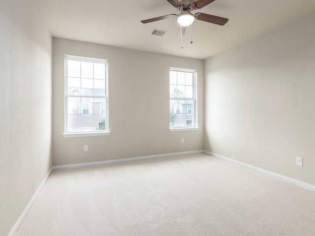 spare room with light carpet and ceiling fan