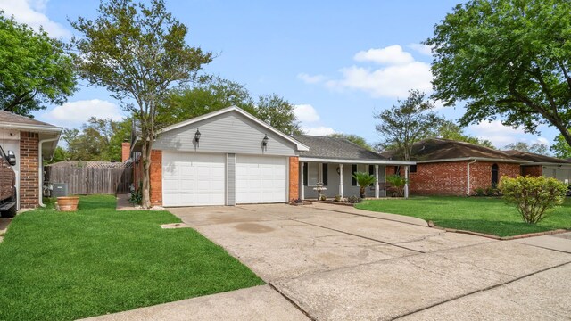 single story home with a garage and a front lawn