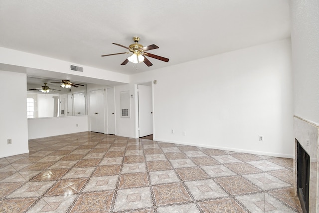 unfurnished living room with ceiling fan and a premium fireplace