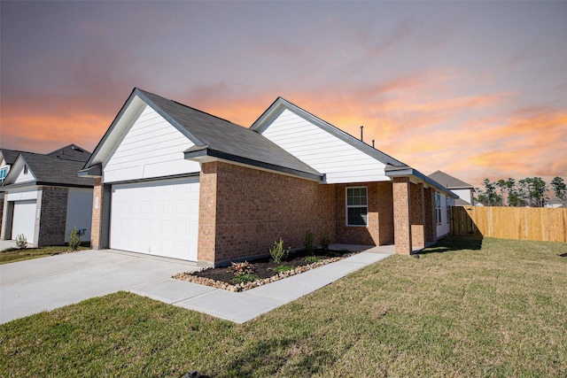 view of front of home featuring a lawn and a garage