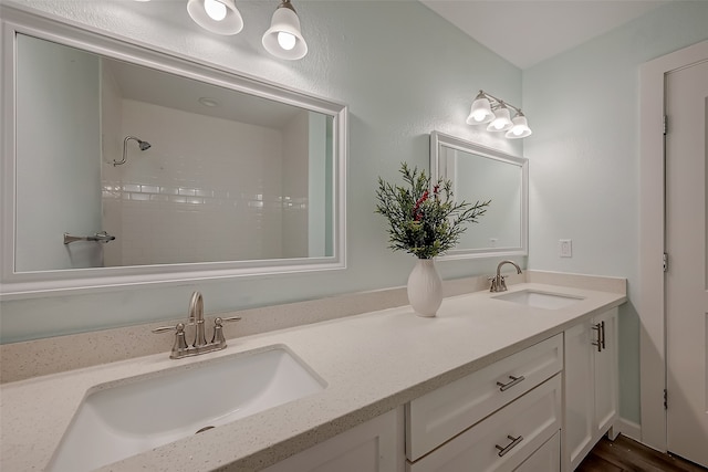 bathroom with vanity, hardwood / wood-style flooring, and a shower