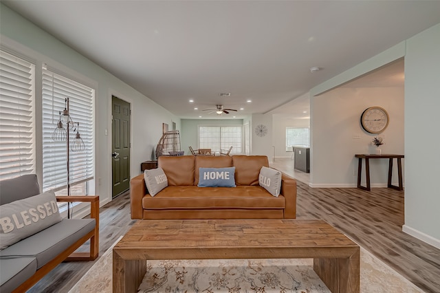 living room with hardwood / wood-style floors and ceiling fan