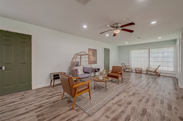 living room with light wood-type flooring and ceiling fan