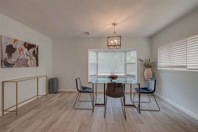 dining room featuring light hardwood / wood-style floors and an inviting chandelier