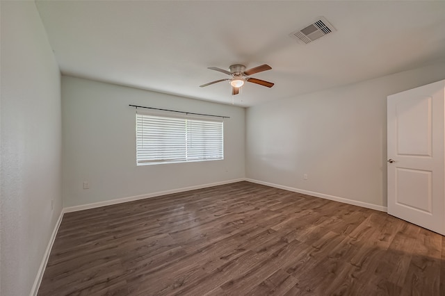 spare room with ceiling fan and dark hardwood / wood-style floors