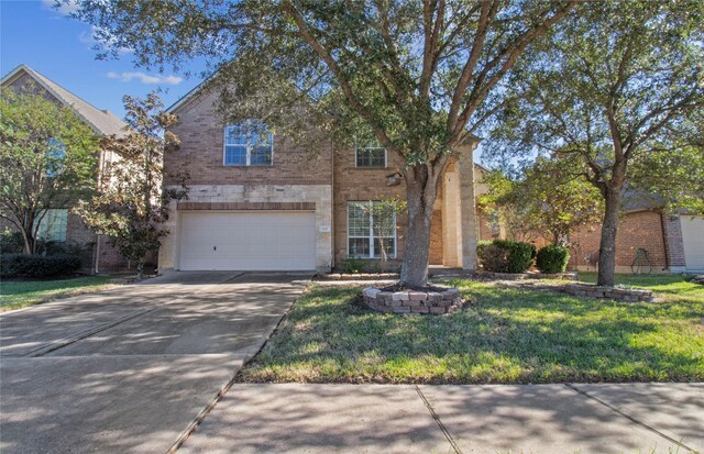 view of front of property featuring a front yard and a garage