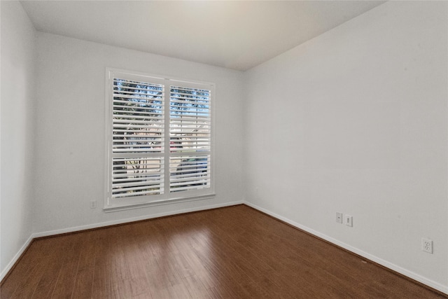 empty room with hardwood / wood-style flooring