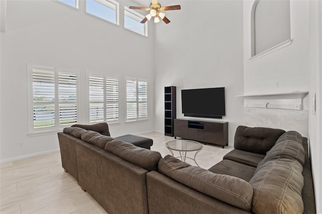 living room featuring a towering ceiling and ceiling fan