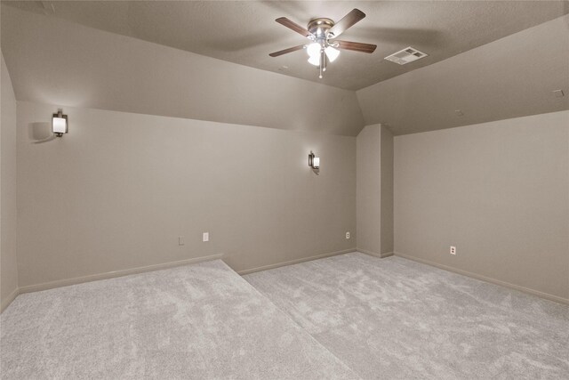 bonus room featuring ceiling fan, lofted ceiling, and light carpet