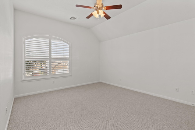 unfurnished room featuring ceiling fan, light colored carpet, and vaulted ceiling