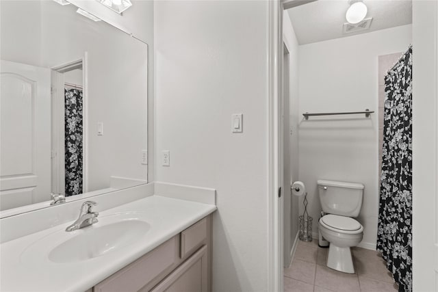 bathroom featuring vanity, toilet, and tile patterned floors