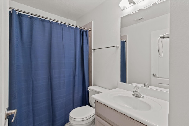 bathroom featuring vanity, a shower with shower curtain, and toilet