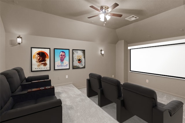 carpeted cinema room with ceiling fan, a textured ceiling, and vaulted ceiling