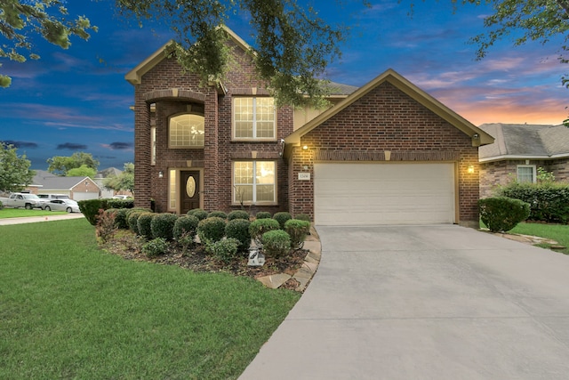 view of front property with a yard and a garage