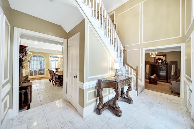 stairs featuring lofted ceiling and an inviting chandelier