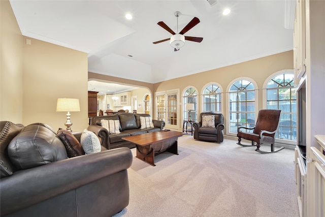 carpeted living room featuring ornamental molding and ceiling fan