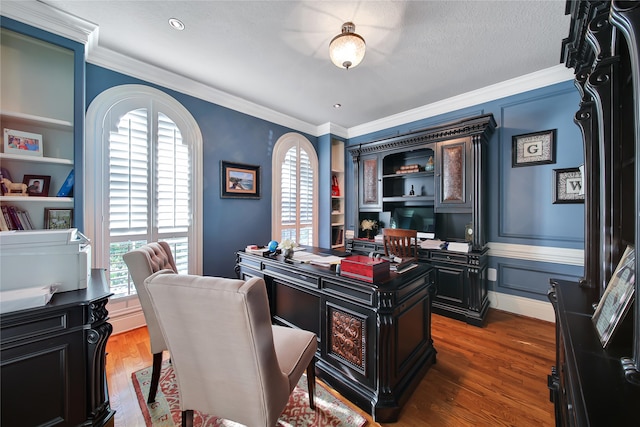 office with dark hardwood / wood-style flooring, a textured ceiling, and crown molding