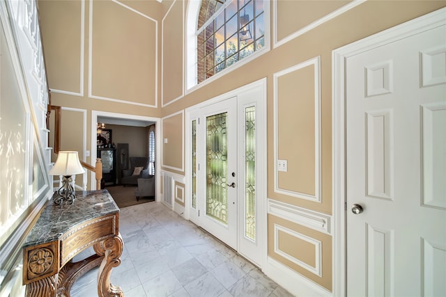 entryway featuring a towering ceiling