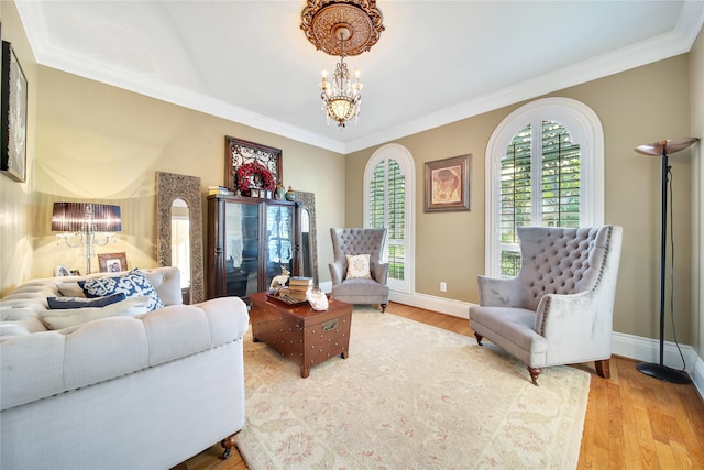 living room with wood-type flooring, an inviting chandelier, and crown molding