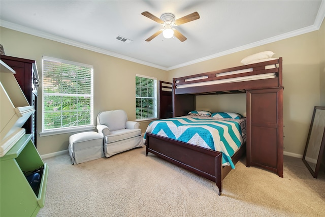 carpeted bedroom featuring ceiling fan and crown molding