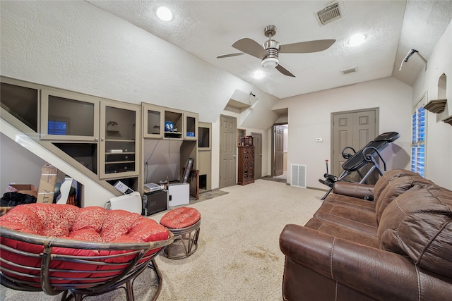 carpeted living room featuring ceiling fan, a textured ceiling, and vaulted ceiling